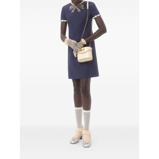 Valentino Short Embroidered Crepe Couture Dress in navy blue with rhinestone embellishments, modeled with gloves and handbag.