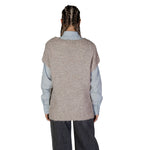 Back view of model wearing Vero Moda Beige Recycled Polyester Sweater with long-sleeve shirt and jeans, emphasizing its sustainable material.