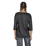 Back view of a woman wearing a Vero Moda Bicolor Recycled Polyester Long Sleeve top, showcasing the metallic textured fabric.