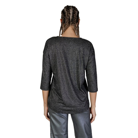 Back view of a woman wearing a Vero Moda Bicolor Recycled Polyester Long Sleeve top, showcasing the metallic textured fabric.