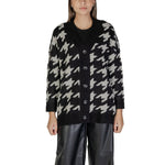 Woman wearing Vero Moda Black And White Marabou Cardigan with houndstooth pattern and black buttons, styled for autumn and winter.