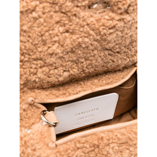 Close-up of Zanellato Postina Baby Teddy handbag showcasing the textured material and label inside the purse.