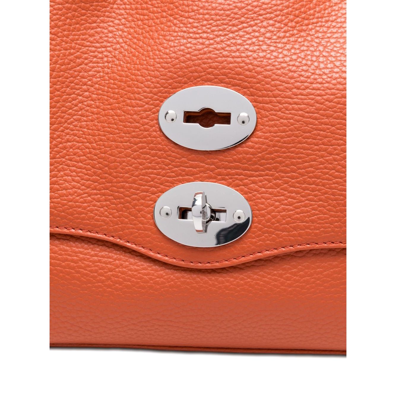 Close-up of orange twist-lock fastening on Zanellato Postina Daily Small leather handbag