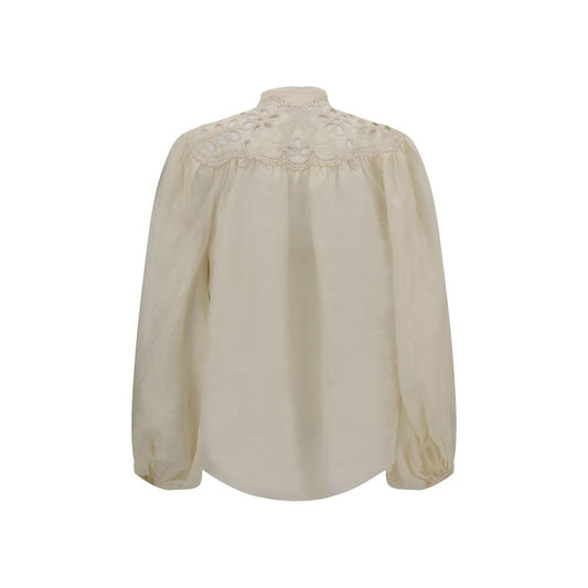 Back view of Zimmermann Embroidered Coco Blouse with puff sleeves, high neck, and lace inserts on lightweight natural ramie fabric.