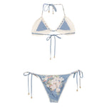 Zimmermann Floral print bikini set in light blue, featuring crochet details, halterneck tie top, and side-tie bottoms.
