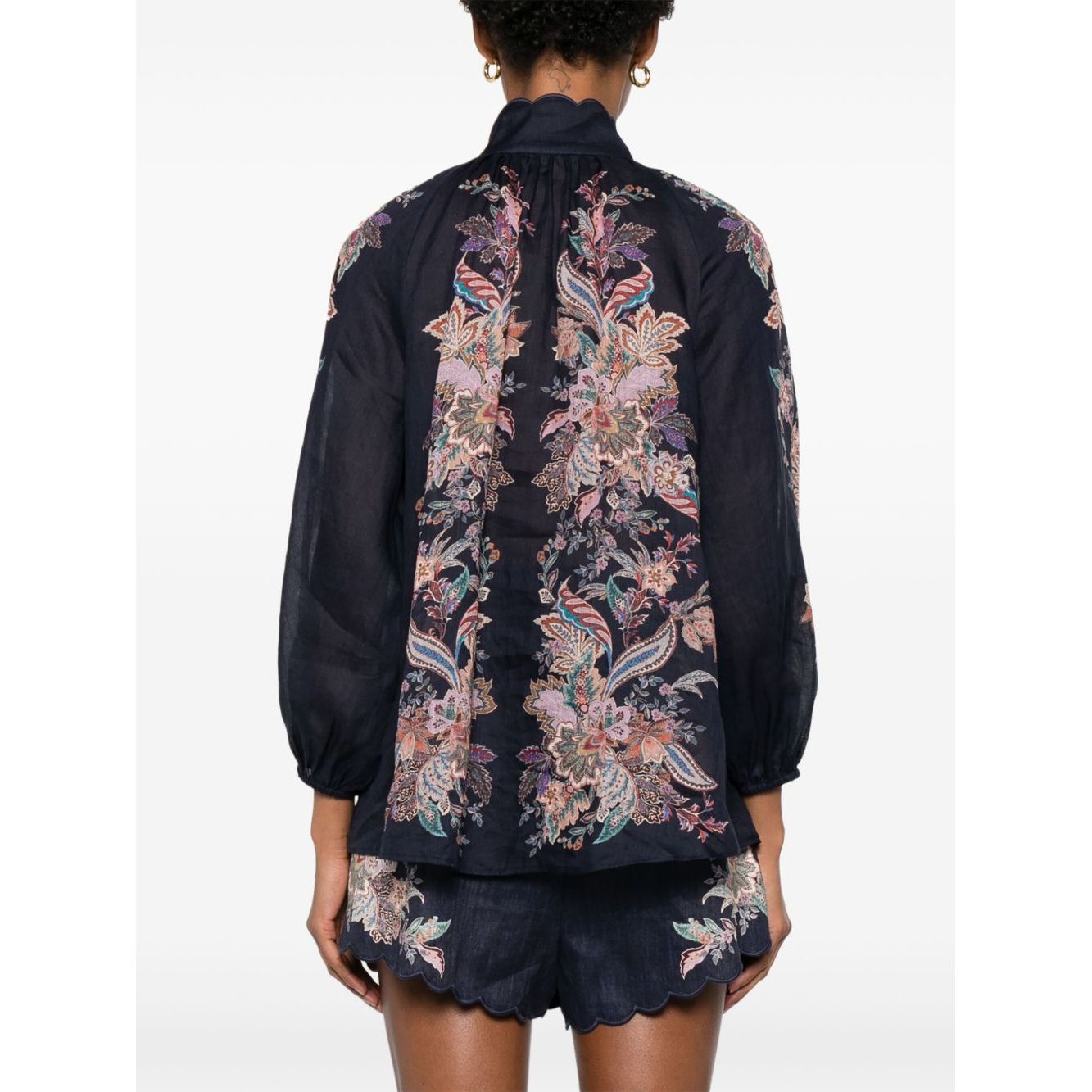 Back view of Zimmermann Rhiannon Billow blouse in navy blue with paisley print, featuring long sleeves and elasticated cuffs.