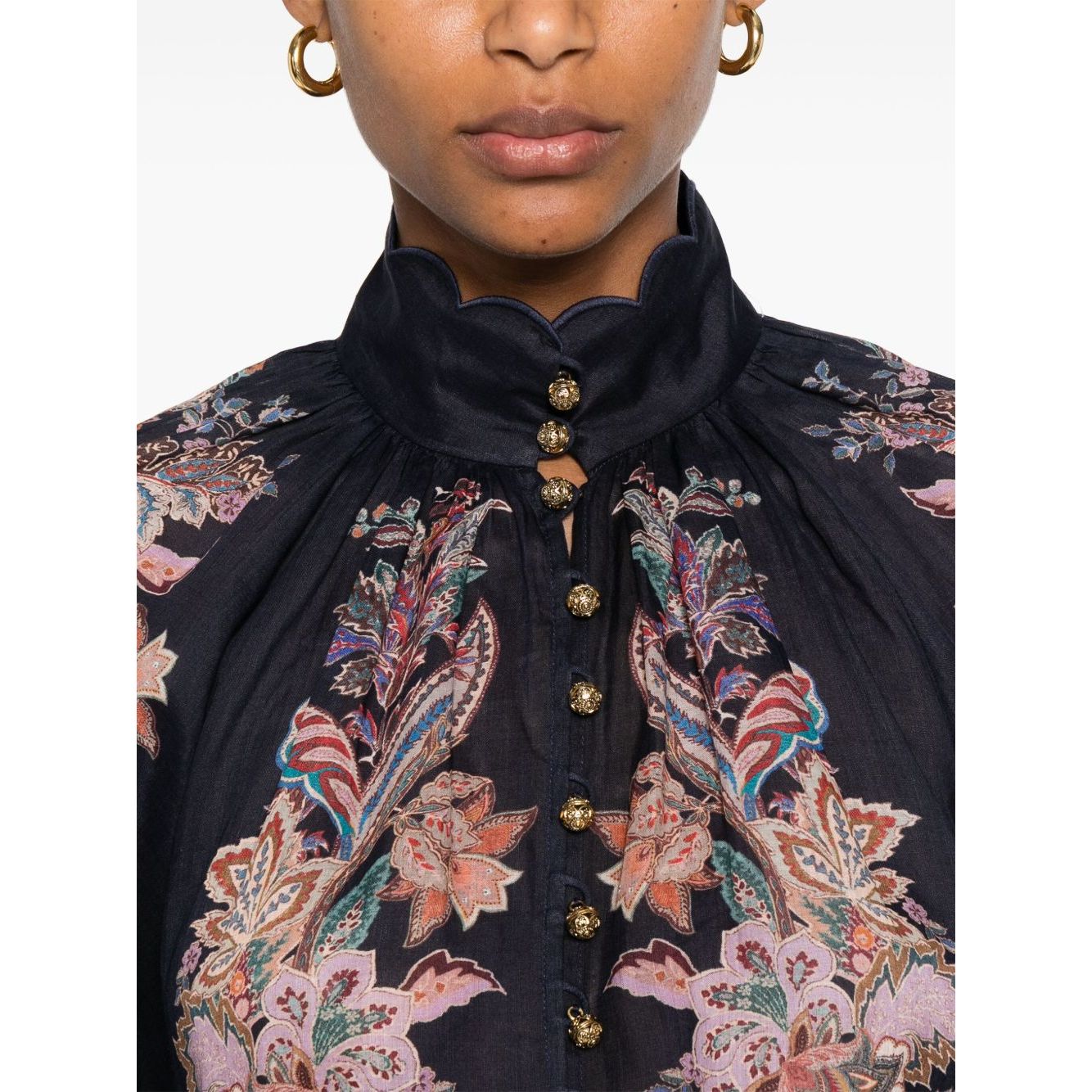 Close-up of Zimmermann Rhiannon Billow blouse in navy blue with paisley print, featuring front button fastening and elasticated cuffs.