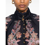 Close-up of Zimmermann Rhiannon Billow blouse in navy blue with paisley print, featuring front button fastening and elasticated cuffs.